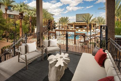 a balcony with chairs and a table and a pool at Silverton Casino Lodge in Las Vegas