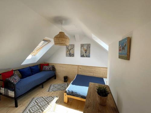 a living room with a blue couch and a table at Domek na Kaszubach 2-1 - Ostoja Bukowo in Borowy Młyn