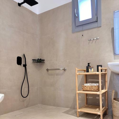 a bathroom with a shower with a phone on the wall at Pyrra apartments in Skiros