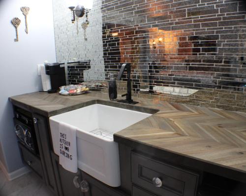 a kitchen with a sink and a brick wall at The Barter Green Room in Abingdon
