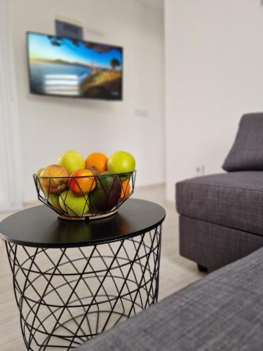 a bowl of fruit on a table in a living room at B&L Apartments in Vir