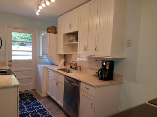 a kitchen with white cabinets and a sink at Endless Beach #B,Oceanfront, 3bedrooms-2bath-Pet Friendly in Virginia Beach