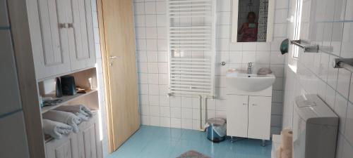 a white bathroom with a sink and a toilet at Casa Adriana in Eforie Sud