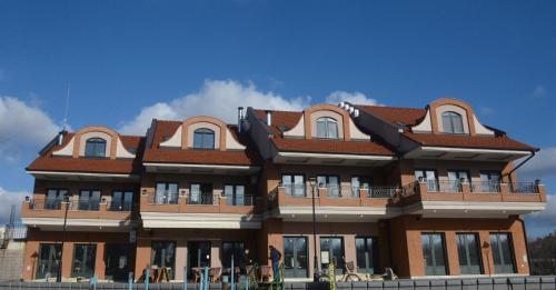 a large brick building with a red roof at Soul River e cucina in Pančevo