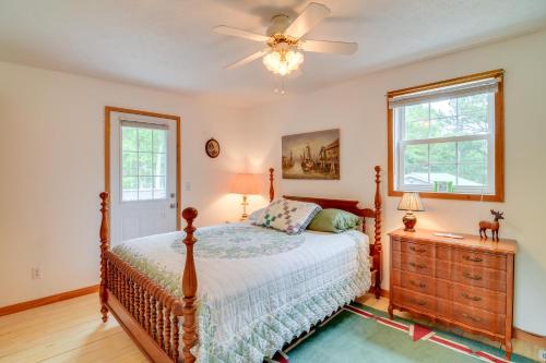 a bedroom with a bed and a ceiling fan at Tennessee Cabin Getaway Near Dale Hollow Lake! in Frogue