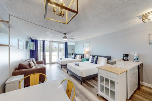 a living room with a bed and a couch at The Top of the Gulf #112 in Panama City Beach