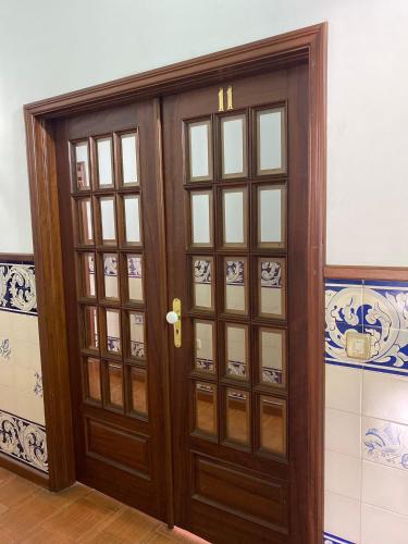 a wooden door with glass panels in a room at Casa Augusta - QUINTA in Penafiel