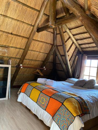 a bedroom with a bed in an attic at Sweet Melody Tree House in Gaborone