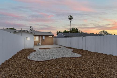 a backyard with a white fence and a house at Simi-valley Apartment By Pmi in Simi Valley