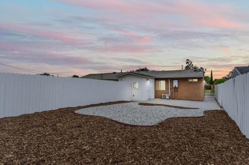 a backyard with a white fence and a house at Simi-valley Apartment By Pmi in Simi Valley