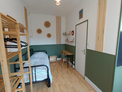 a bedroom with a bunk bed and a desk at Les Madeleines de Saint-Omer in Saint-Omer