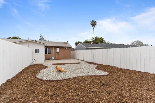 a backyard with a white fence and a gravel driveway at Simi-valley Apartment By Pmi in Simi Valley