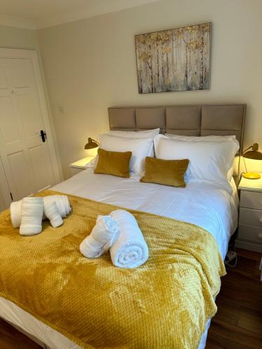 a bedroom with a bed with towels on it at Firbrook House in Ardara