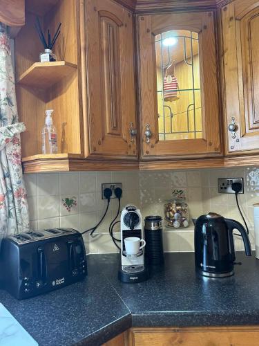 a kitchen counter with a toaster and a coffee maker at Firbrook House in Ardara