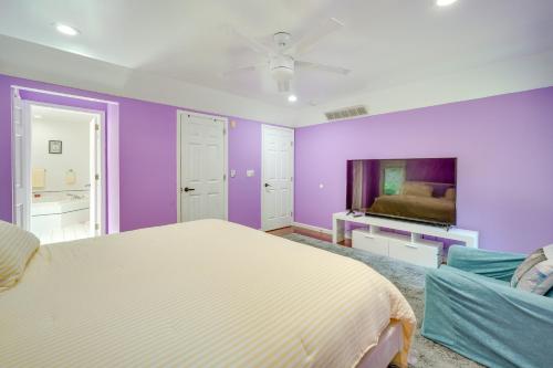 a bedroom with purple walls and a bed at Porch and Fire Pit Shawnee on Delaware Home! in East Stroudsburg