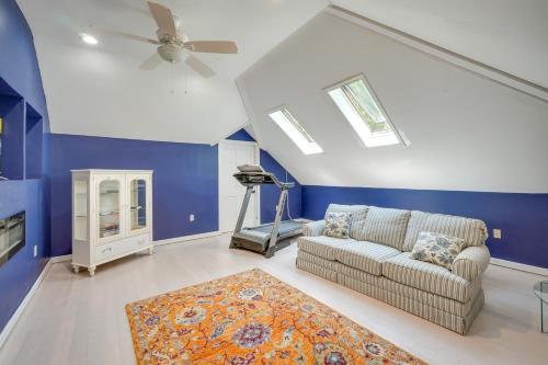 a living room with a couch and a ceiling fan at Porch and Fire Pit Shawnee on Delaware Home! in East Stroudsburg