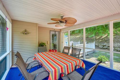 a screened in porch with a table and chairs at Porch and Fire Pit Shawnee on Delaware Home! in East Stroudsburg