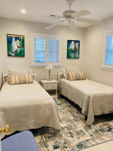 a bedroom with two beds and a ceiling fan at Endless Beach #A,Oceanfront,3bedrooms-2bath-Pet Friendly in Virginia Beach