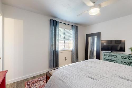 a bedroom with a bed and a tv and a window at South Austin Life in Austin