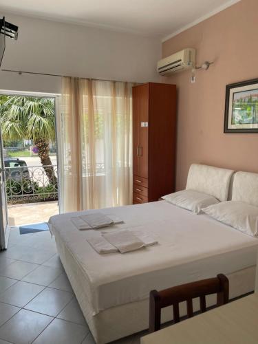 a bedroom with a large bed and a balcony at Apartments SoleMar2 in Sutomore