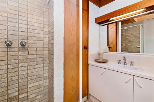 a bathroom with a sink and a shower at 11 Cottesloe - steps from beach - sleeps 3 in Perth