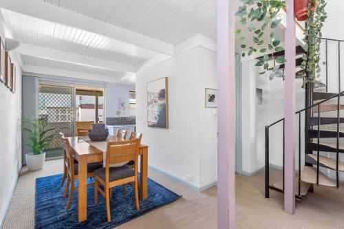 a dining room with a table and chairs at 13 Cottesloe - steps from beach - sleeps 3 in Perth