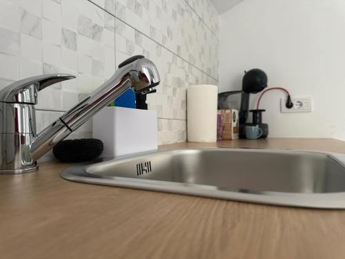 a kitchen counter with a sink in a kitchen at Vila Ema in Bajina Bašta