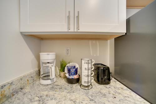 a kitchen counter with two coffee makers on it at Bright Gadsden Apartment about 10 Mi to Dive Land Park in Gadsden