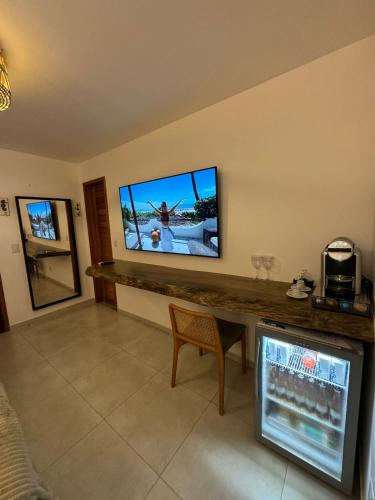 a living room with a flat screen tv on a wall at Pousada Amazing Jeri in Jericoacoara