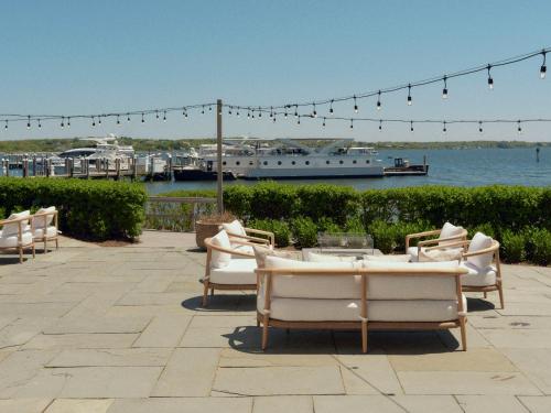 a group of chairs sitting on a patio near the water at Montauk Yacht Club in Montauk
