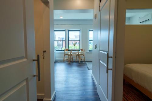a hallway with a room with a bed and a table at The Standard Downtown Columbus in Columbus