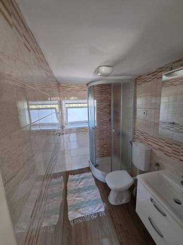 a bathroom with a toilet and a sink at Apartments Stefanovski Paradiso in Veli Lošinj