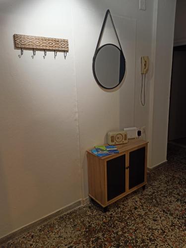 a room with a mirror on the wall and a table at Olympus Terra Apartments No1 in Litochoro