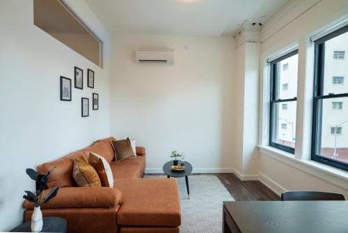 a living room with a couch and a table at The Standard Downtown Columbus in Columbus