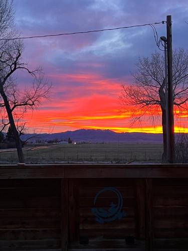 a sunset view from a window of a field at Hudson House Bed and Breakfast in Wheatland