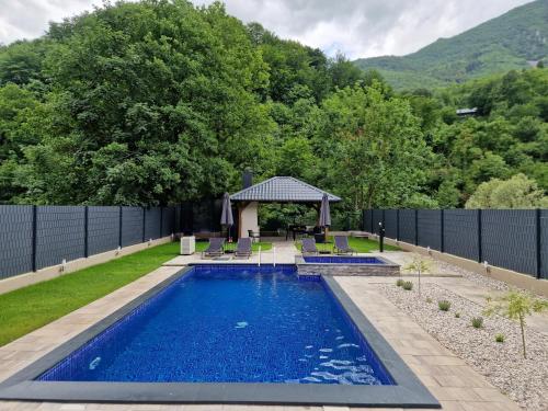 a swimming pool in the backyard of a house at Villa Jenna in Glavatičevo