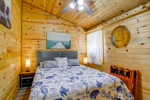 a bedroom with a bed in a wooden cabin at Maryland Retreat Walk to Bay, Beach and Boat Ramp! in Deal Island