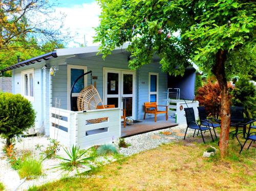 a tiny house with a porch and a patio at Leśny zakątek malediwy Jacuzzi free in Jaworzno