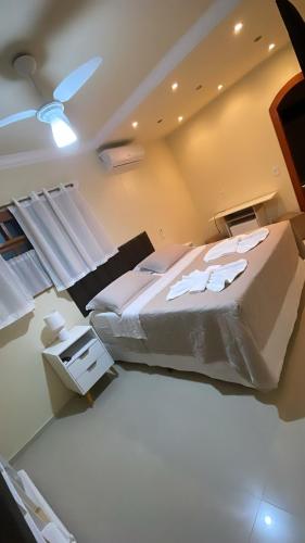 a large bedroom with two beds and a ceiling at Espaço Nobre in Cunha