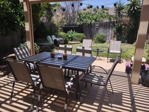a blue table and chairs on a patio at Custom Home - Beach close/convenient to everything in Oceanside
