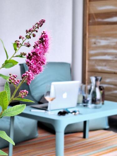 a blue coffee table with a laptop on it at Strandhaus Chiemsee in Übersee