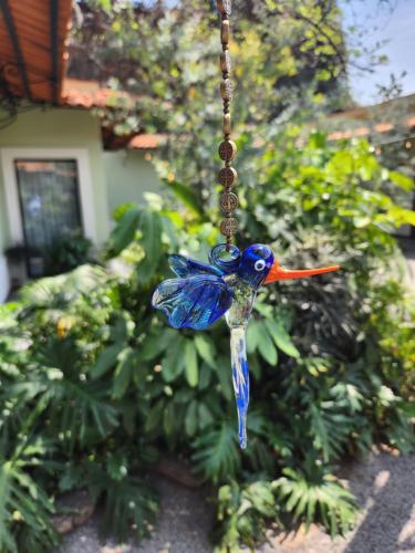 a blue bird ornament hanging from a string at Villa Escondida in Guadalajara
