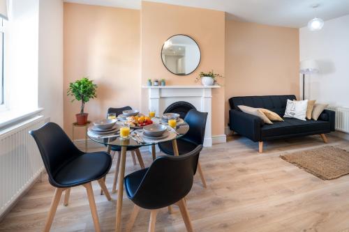 a living room with a table and chairs and a couch at Terracotta Apartment, free WiFi & parking, coastal location in New Brighton