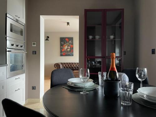a dining room table with a bottle of wine and glasses at Wellness Suite für 2 Personen mit Sauna und Billardtisch in Altenau