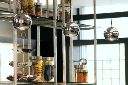 a kitchen with pots and pans on a shelf at Rosslyn Central Park Hotel Sofia in Sofia