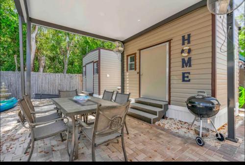 a patio with a grill and a table and chairs at Paradise key largo in Key Largo