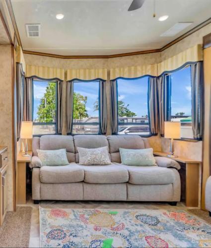 a living room with a couch and some windows at Paradise key largo in Key Largo