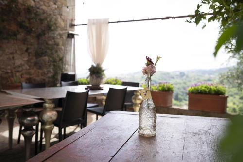 a vase with flowers sitting on a wooden table at Società agricola Scerba srl in Montemagno