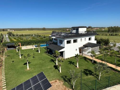 an aerial view of a house with solar panels at Bens White House in AÃ¯n el Ksob