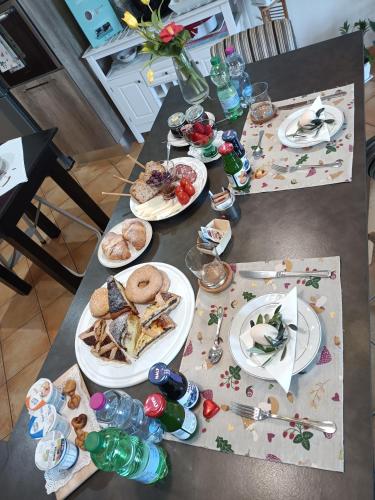 a table with plates of food and drinks on it at Il Faggio 17 B&B in Artena